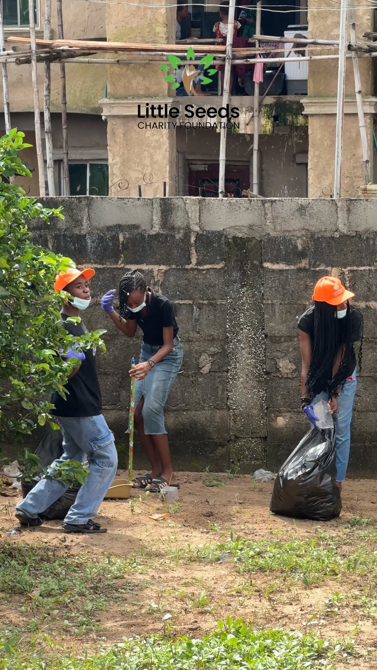 Young volunteers cleaning an outdoor space