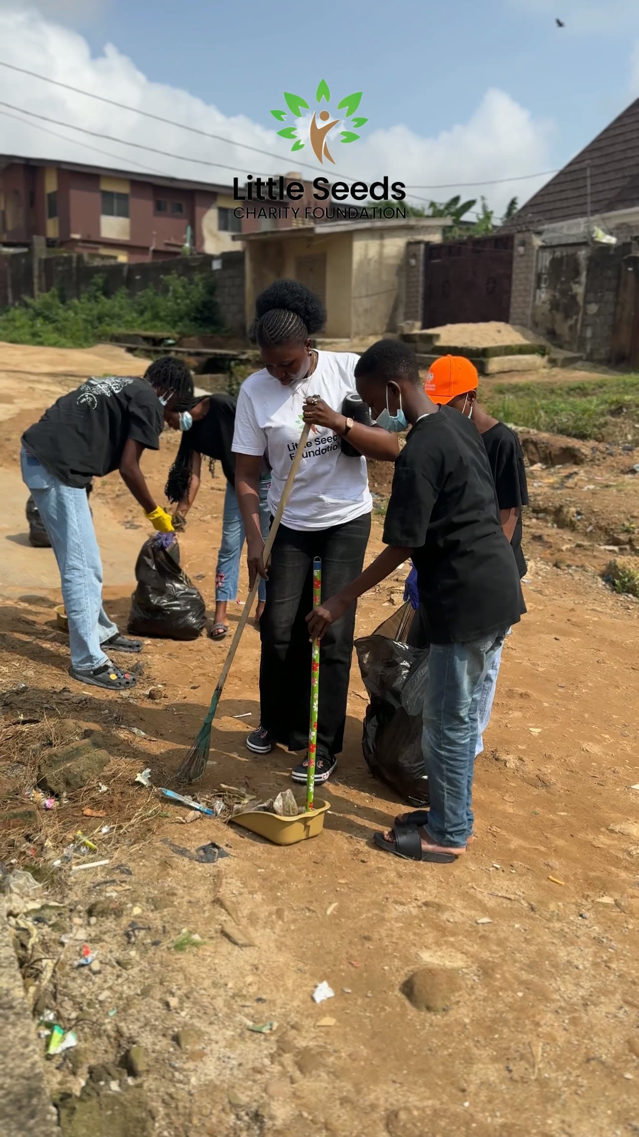 Teenagers clearing overgrown ground during the cleanup